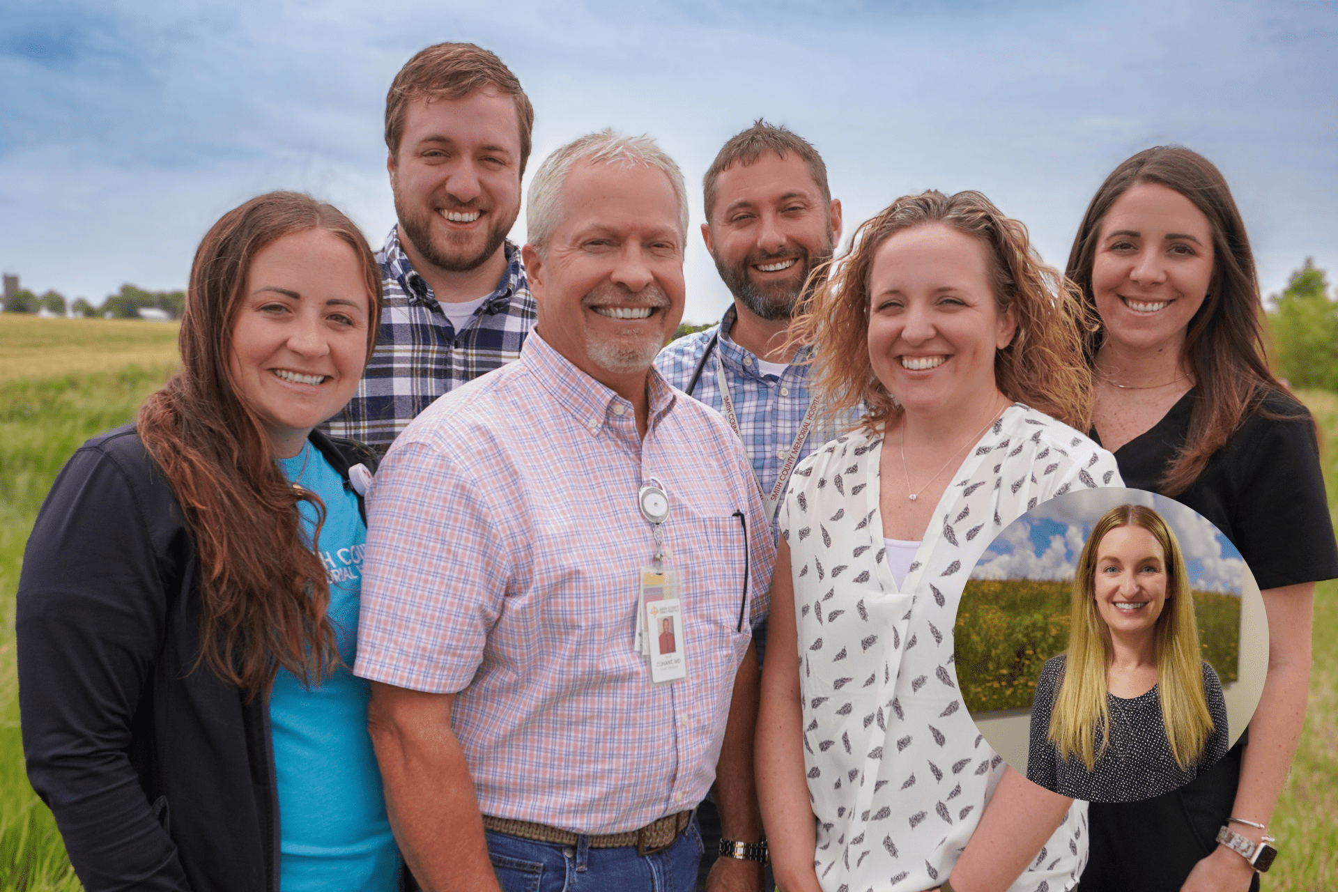 Smith County Family Practice Providers smile for a photo outside the hospital with a field in the background.